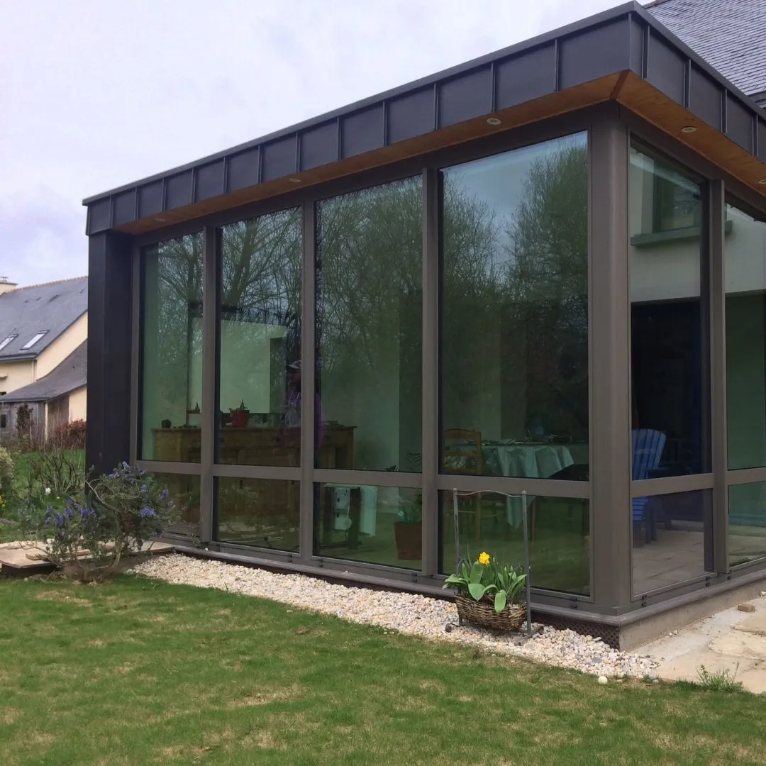 Extension vitrée avec toiture zinc
